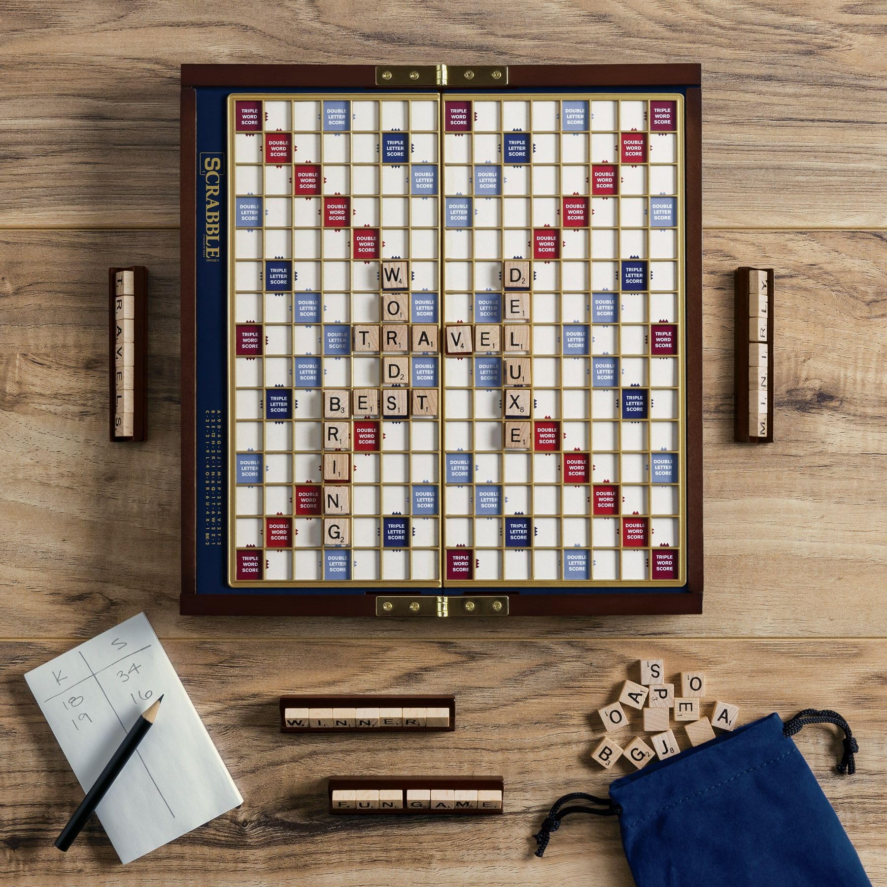 WS Game Company Travel Games collection featuring the Scrabble Deluxe Travel Edition with a folding wood cabinet, raised letter grid, and matching wooden tile racks.