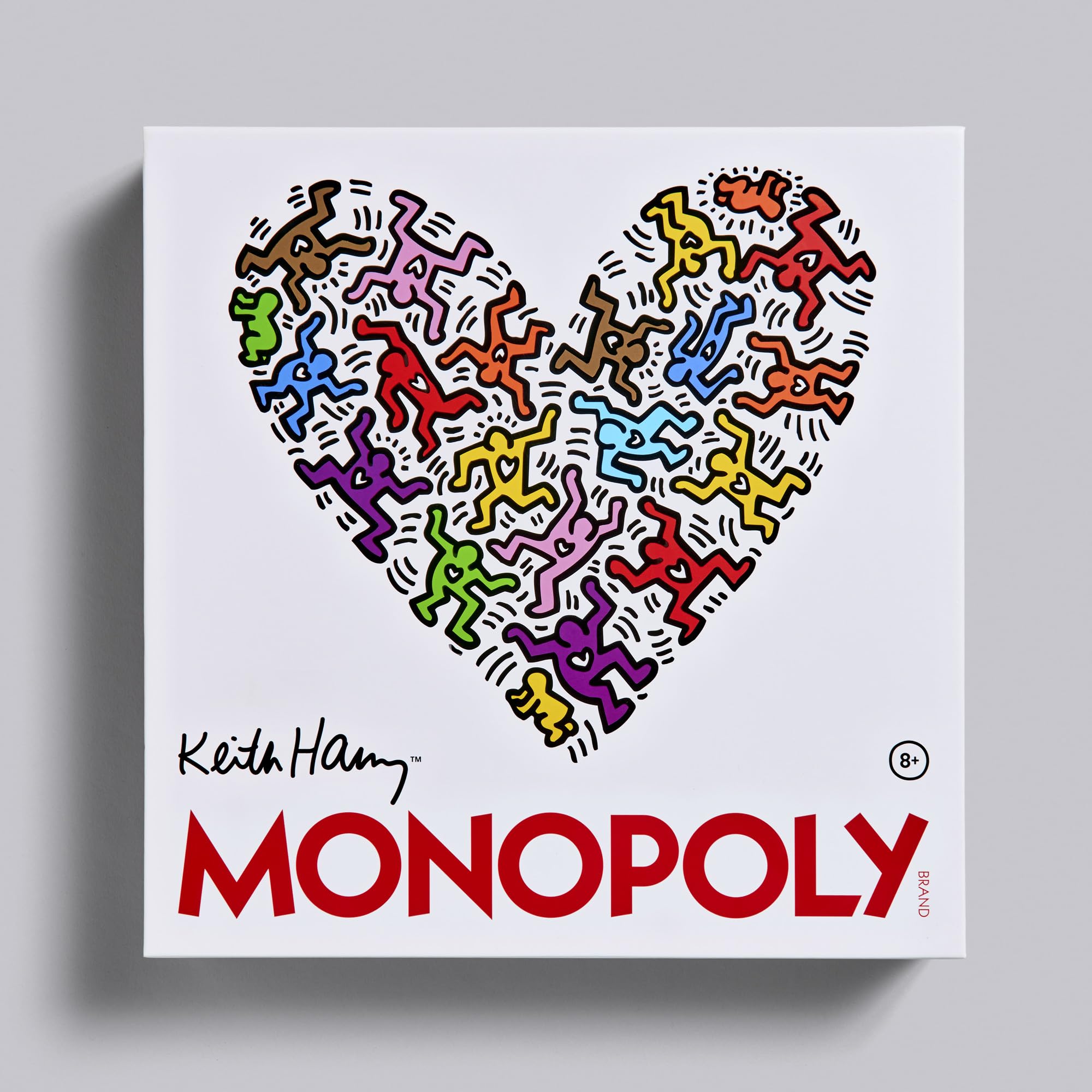 Keith Haring Monopoly game box with colorful heart design and Keith Haring signature on a gray background