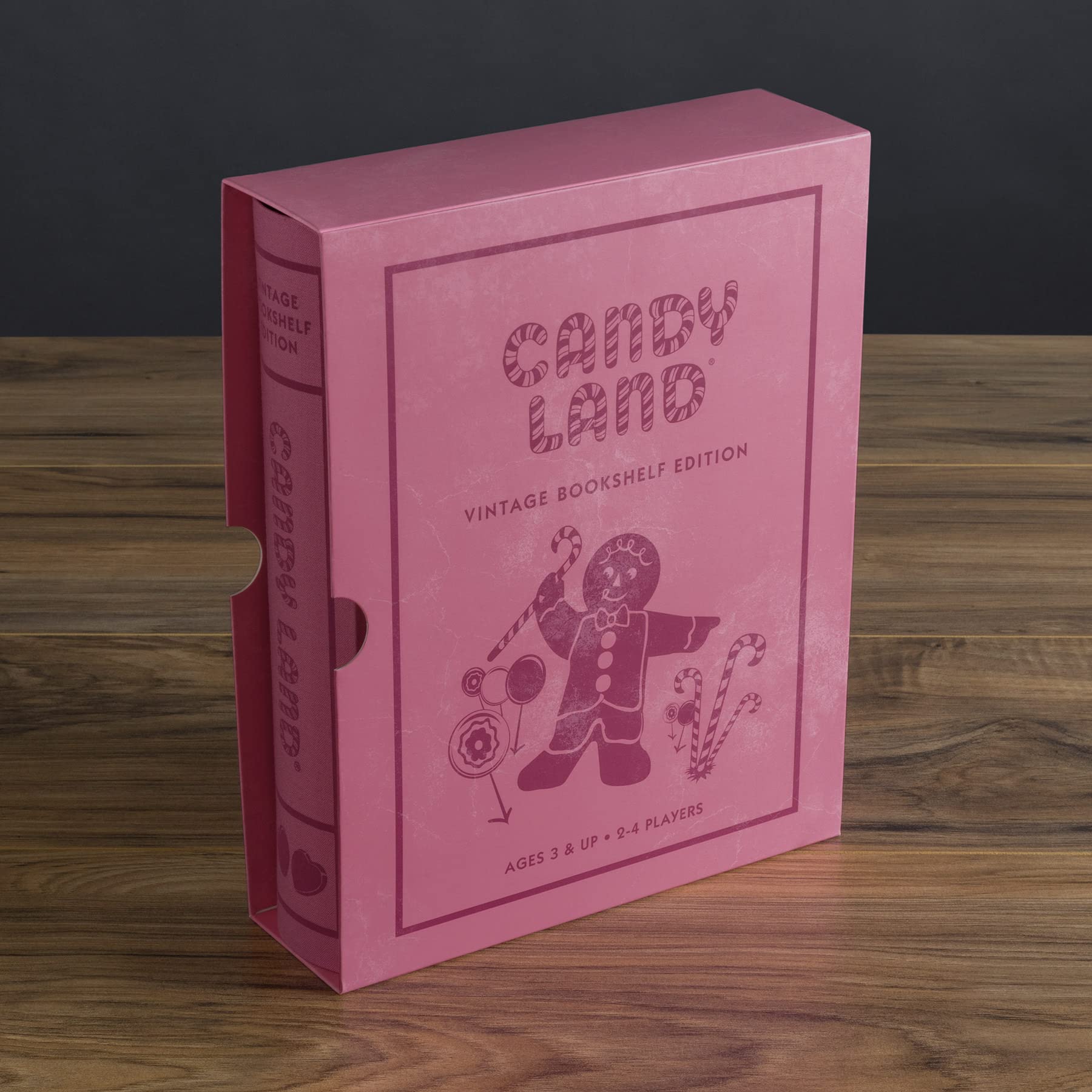 Pink 'Candy Land' vintage bookshelf edition on a wooden surface with a dark background