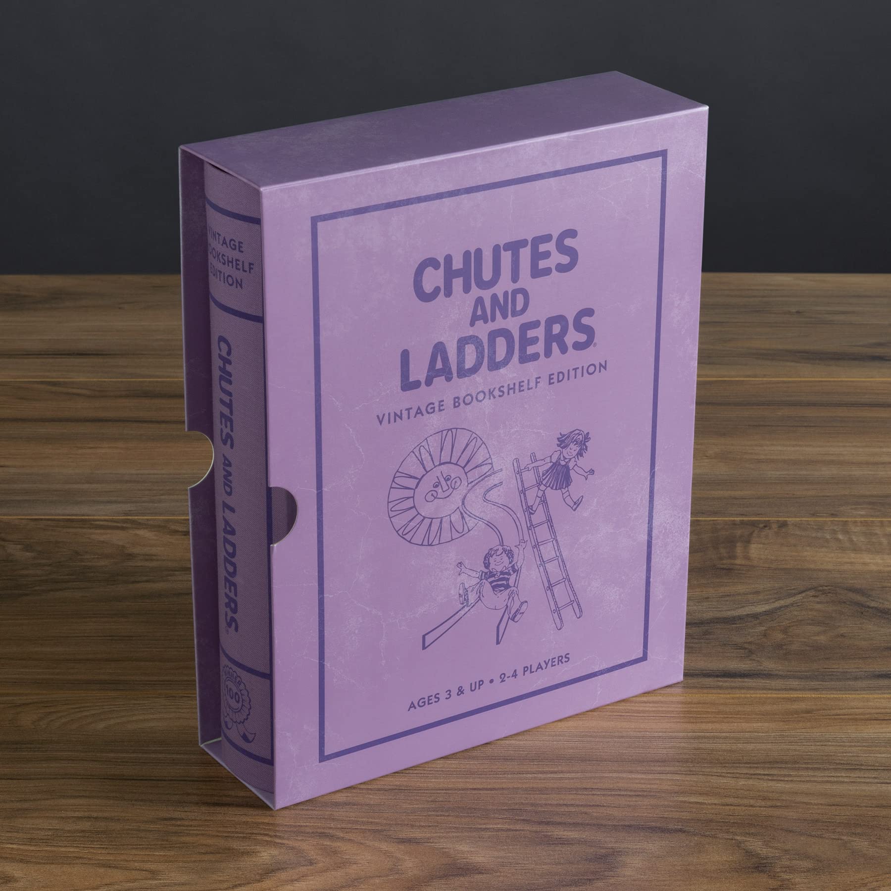 Purple 'Chutes and Ladders' game box on a wooden surface with a dark background
