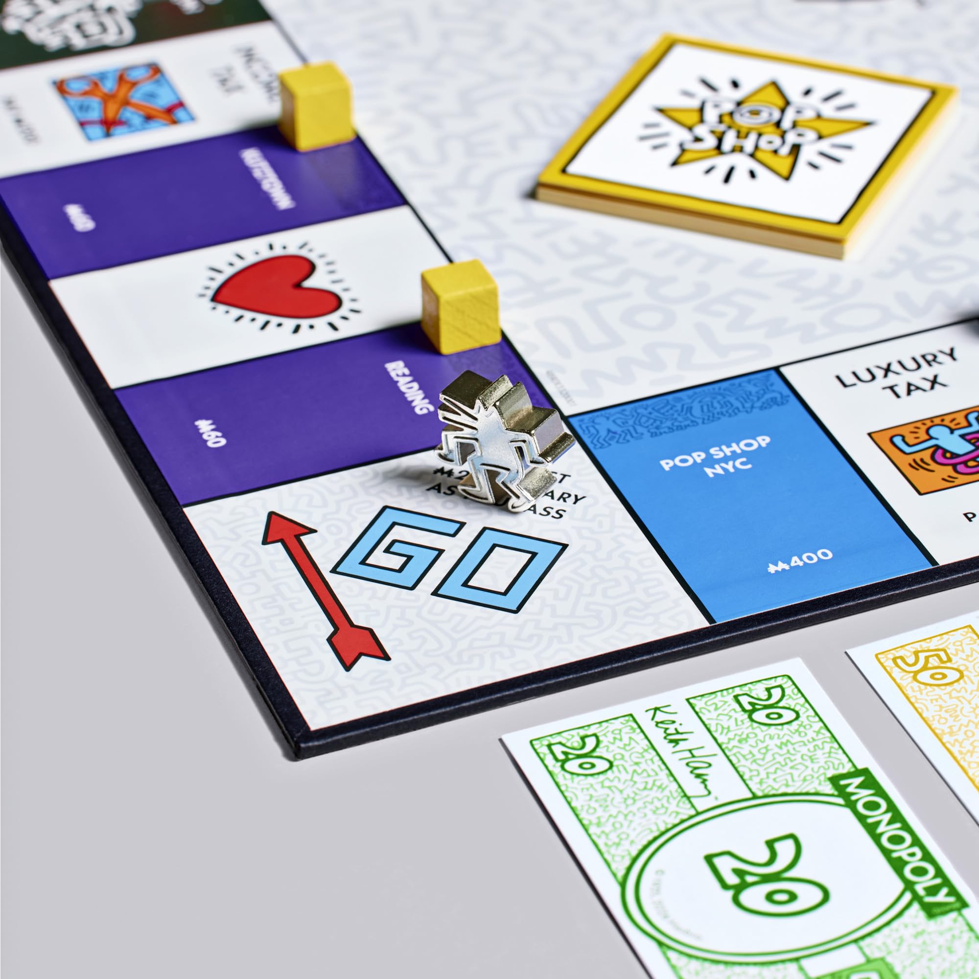 Close-up of a Monopoly game board with property cards and a player's token.