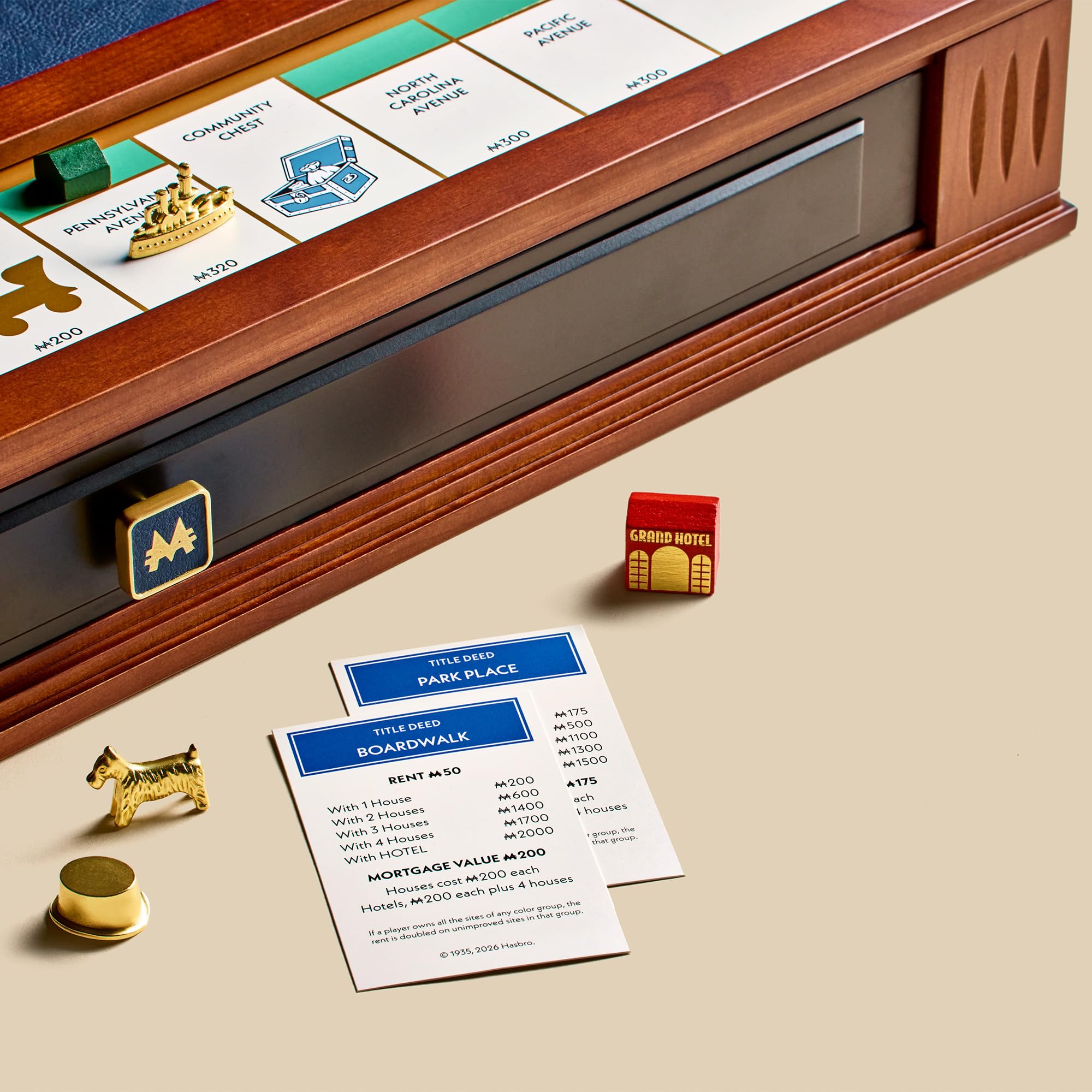 Close-up of a Monopoly game board with pieces and cards on a beige surface.