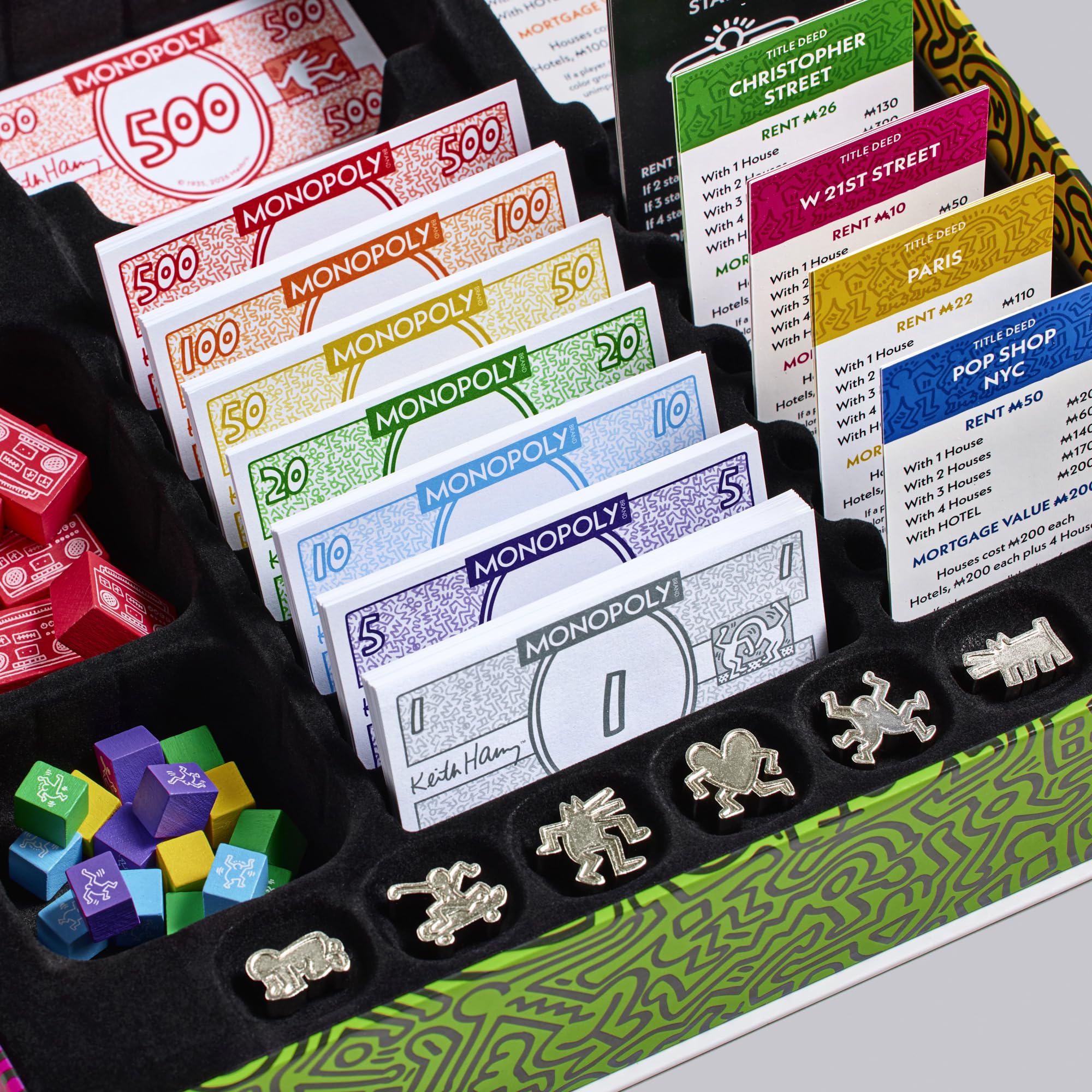 Monopoly game pieces and cards displayed in a holder