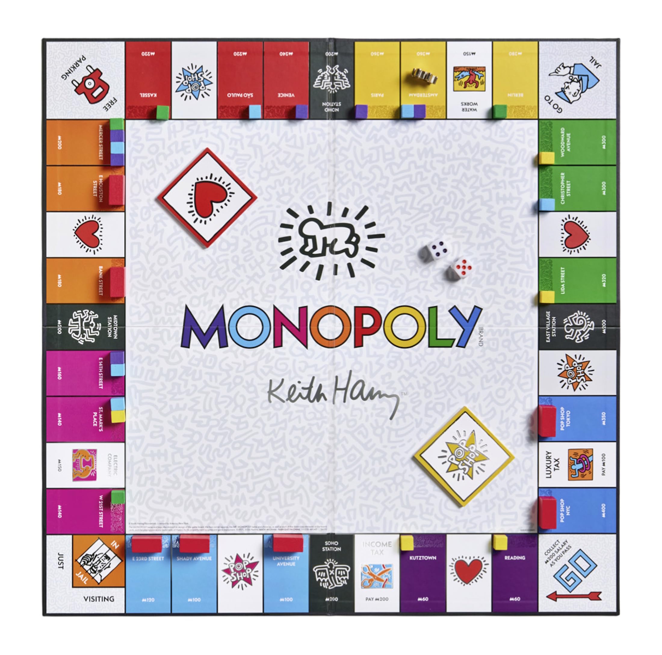 Monopoly board game with colorful property cards and game pieces on a white background