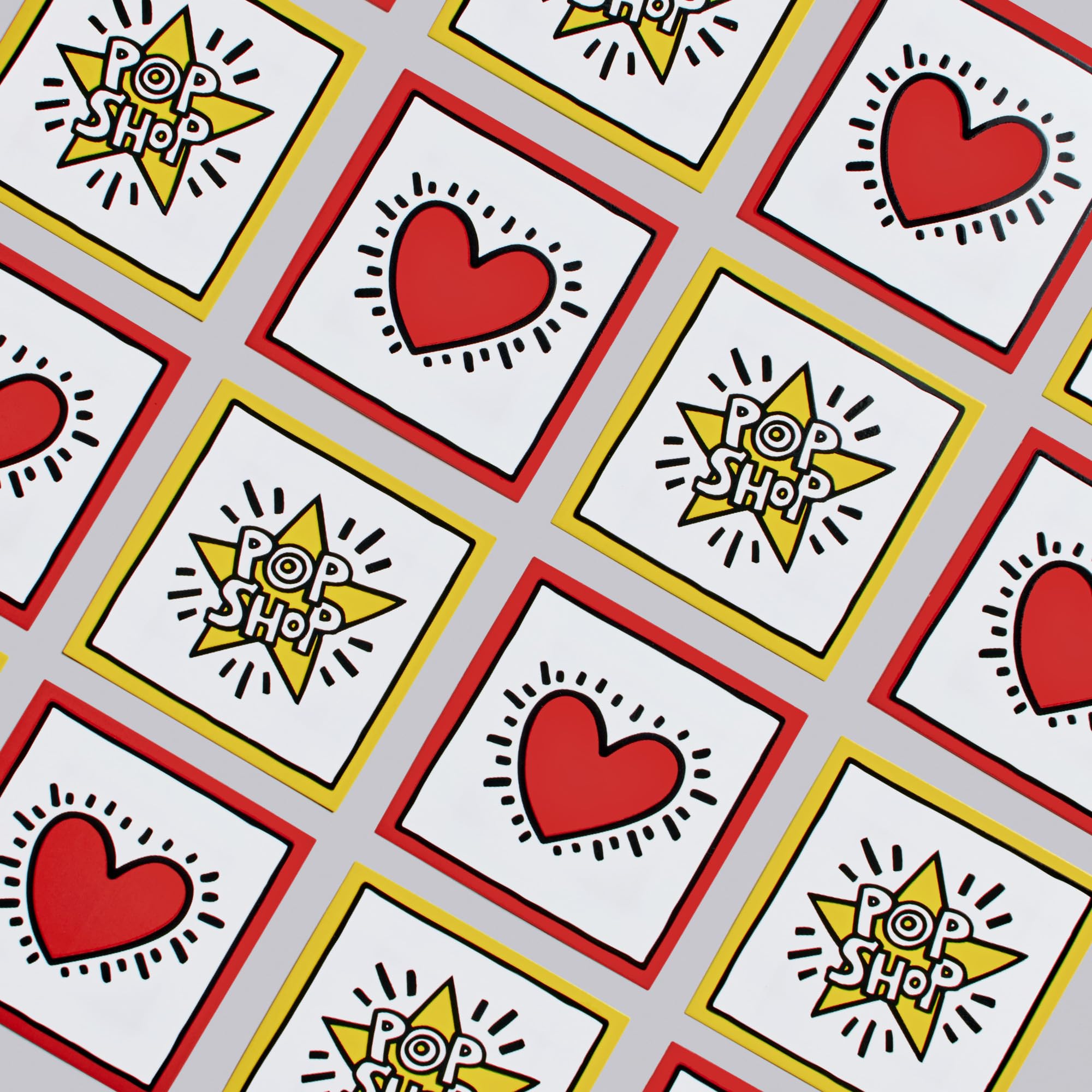 Pattern of red hearts, yellow stars, and 'Pop Shop' logos on a gray background.